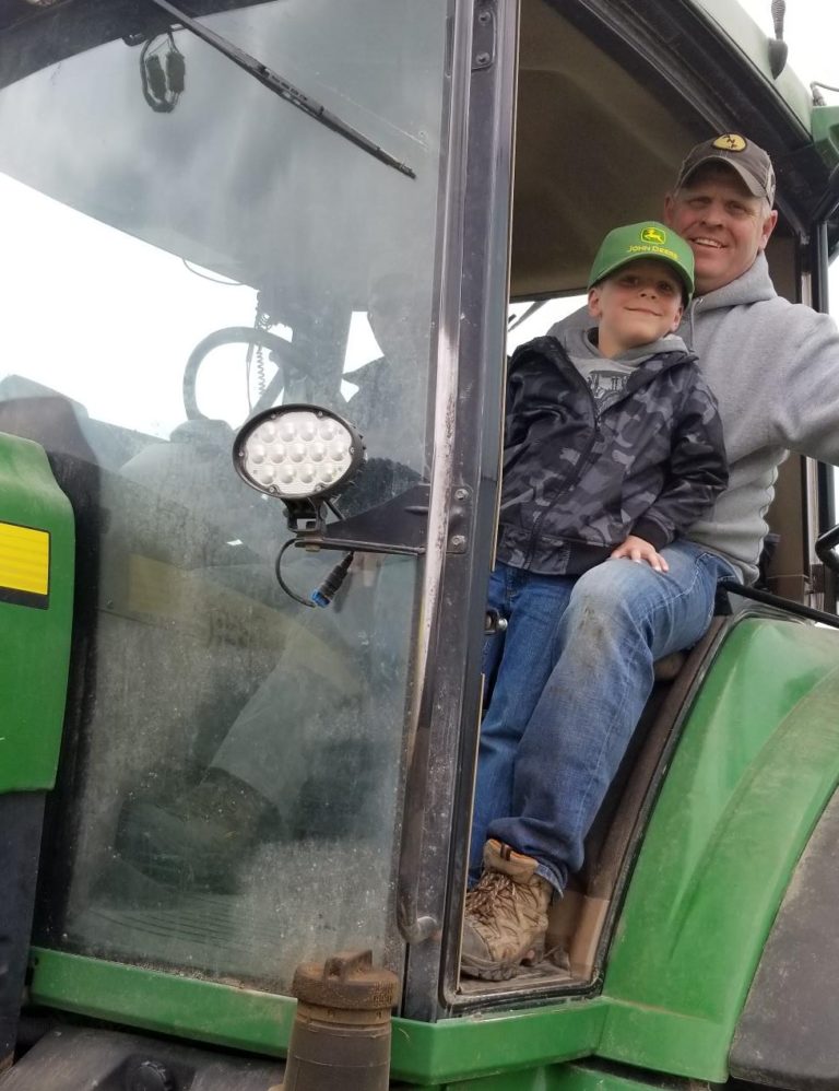 Father and son on tractor